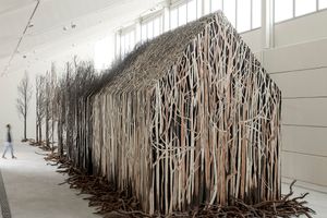 Doris Salcedo, _Uprooted_ (2020–2022). 804 dead trees and steel. 3000 x 650 x 500 cm. Exhibition view: Sharjah Biennial 15, Kalba Ice Factory, Sharjah Art Foundation (7 February–11 June 2023). Courtesy the artist. Photo: Juan Castro.
